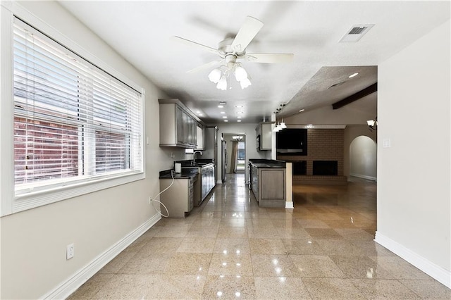 kitchen with dark countertops, ceiling fan, granite finish floor, baseboards, and visible vents