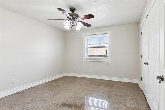 unfurnished bedroom with a closet, baseboards, and ceiling fan