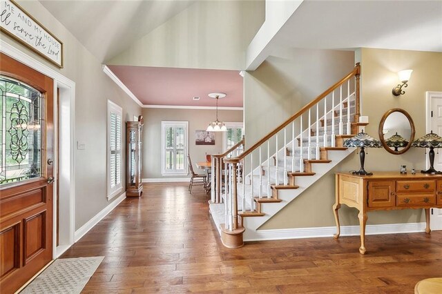 201 Laurel Ct, Luling, LA 70070 - entrance foyer with baseboards, ornamental molding, stairs, and wood-type flooring