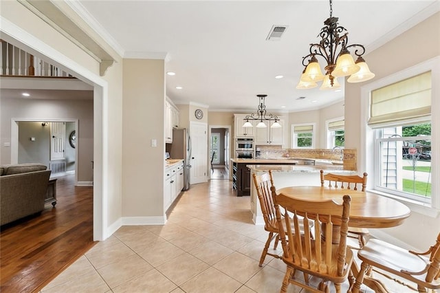201 Laurel Ct, Luling, LA 70070 - dining area featuring crown molding, a chandelier, visible vents, light tile patterned flooring, and recessed lighting
