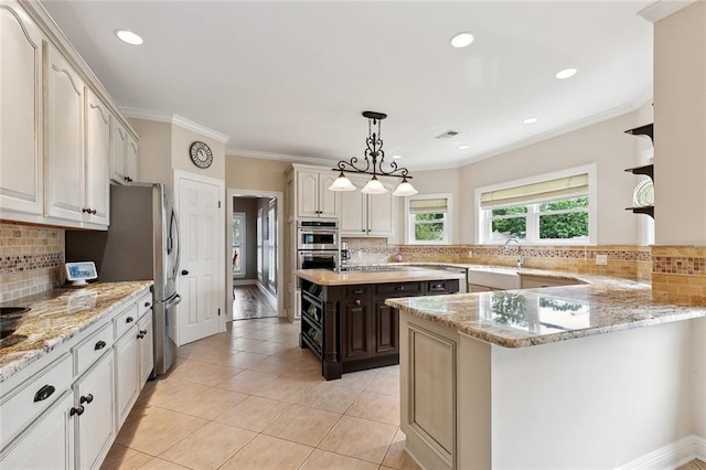 201 Laurel Ct, Luling, LA 70070 - kitchen featuring light tile patterned flooring, hanging light fixtures, backsplash, and stainless steel appliances