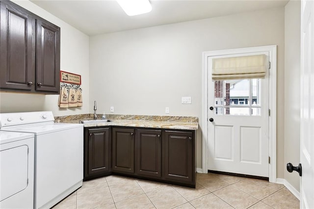 201 Laurel Ct, Luling, LA 70070 - laundry area with light tile patterned floors, cabinet space, a sink, baseboards, and washer and clothes dryer