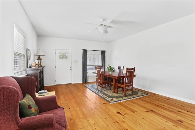 dining room featuring ceiling fan, hardwood / wood-style flooring, and baseboards