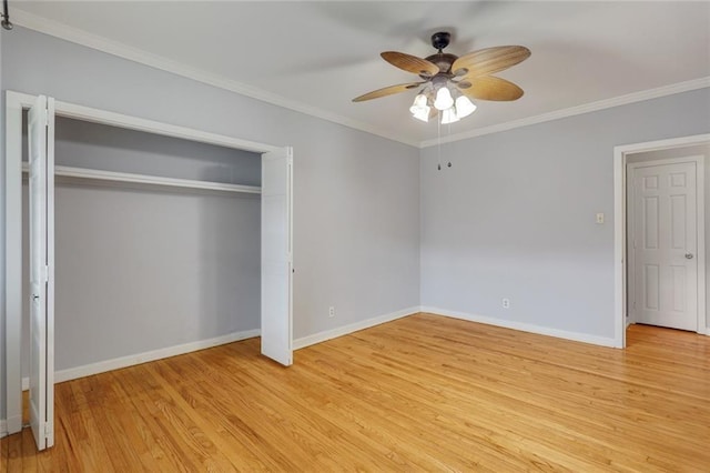 unfurnished bedroom featuring baseboards, crown molding, a closet, and light wood-style flooring