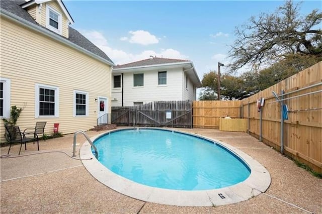 view of pool with a patio, a fenced backyard, and a fenced in pool