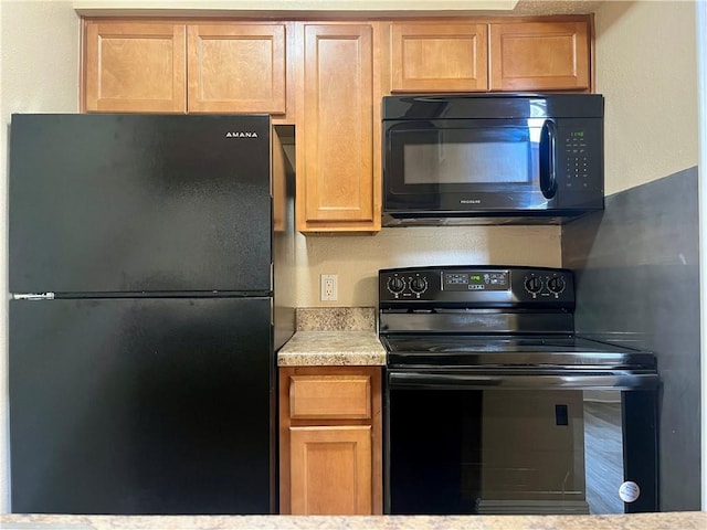 kitchen featuring black appliances and light countertops