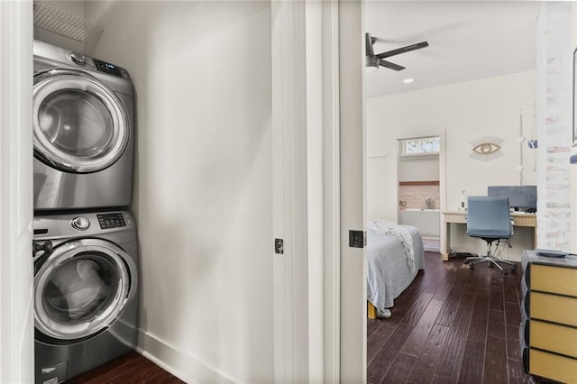 washroom featuring laundry area, hardwood / wood-style flooring, ceiling fan, baseboards, and stacked washer and clothes dryer
