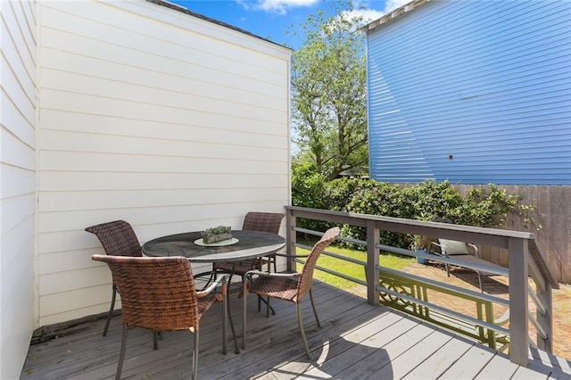 wooden terrace with outdoor dining area