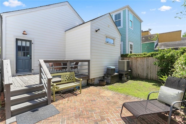 rear view of property featuring a patio, a deck, central AC unit, and fence