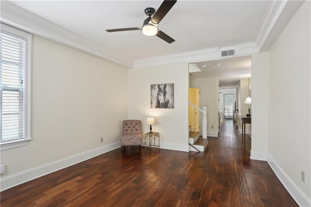 sitting room with ceiling fan, stairs, visible vents, ornamental molding, and hardwood / wood-style floors