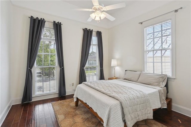 bedroom featuring a ceiling fan, dark wood-style flooring, and baseboards