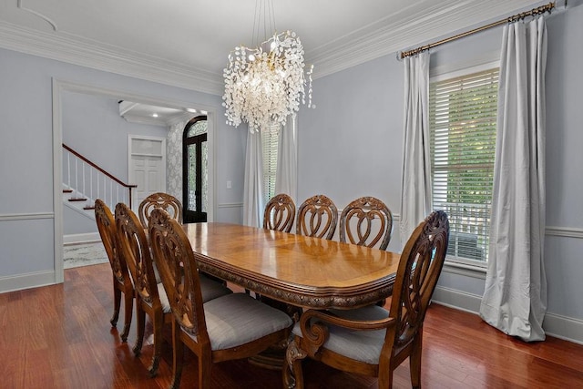 dining space featuring baseboards, plenty of natural light, dark wood-type flooring, and a notable chandelier