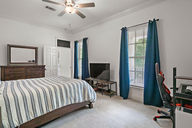 carpeted bedroom with crown molding, multiple windows, a ceiling fan, and visible vents
