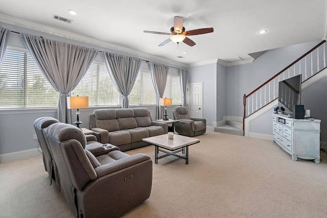 living area featuring ceiling fan, light carpet, plenty of natural light, visible vents, and ornamental molding