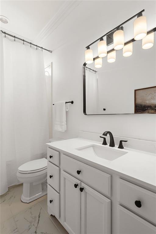 full bath with crown molding, vanity, toilet, marble finish floor, and a shower with shower curtain