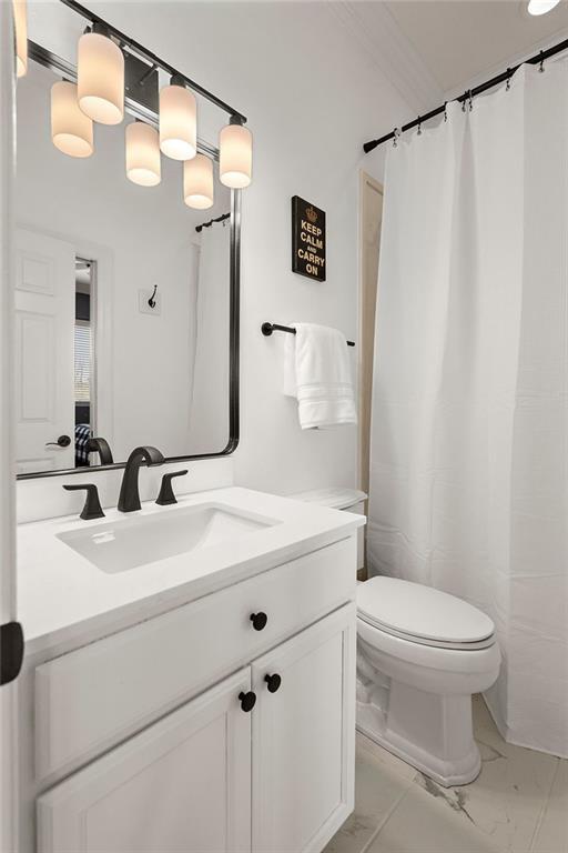 full bathroom with vanity, toilet, and marble finish floor
