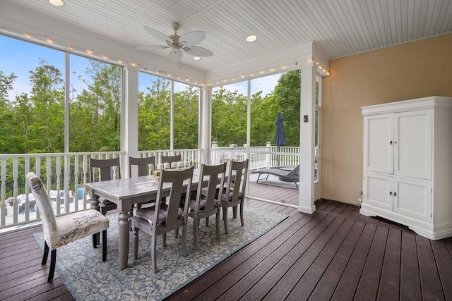 sunroom / solarium with ceiling fan and outdoor dining area