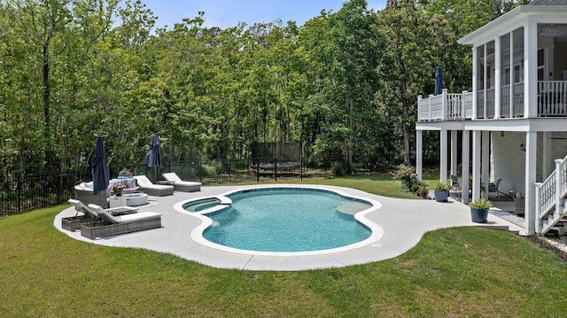 view of swimming pool featuring a patio, a fenced backyard, a sunroom, a trampoline, and a yard