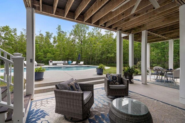 view of patio with fence, a fenced in pool, and an outdoor living space
