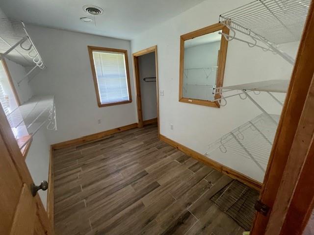walk in closet with visible vents and wood finished floors