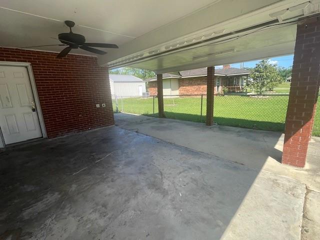 view of patio featuring a ceiling fan and fence
