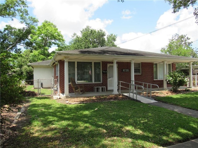 6735 W Magnolia Blvd, Harahan, LA 70123 - view of front of house featuring a porch, brick siding, fence, and a front yard