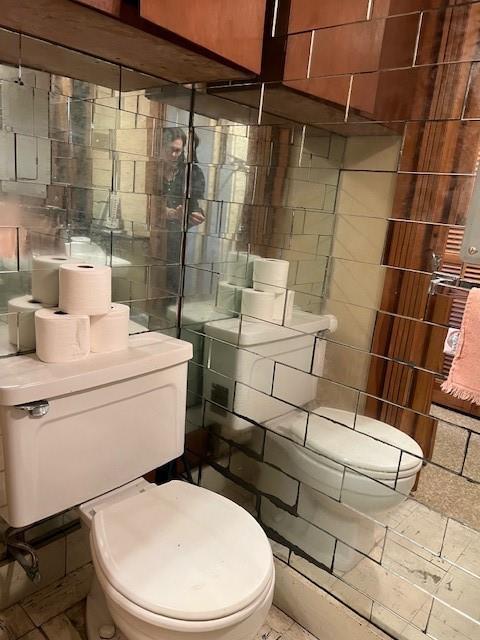 6735 W Magnolia Blvd, Harahan, LA 70123 - bathroom featuring toilet and tile walls