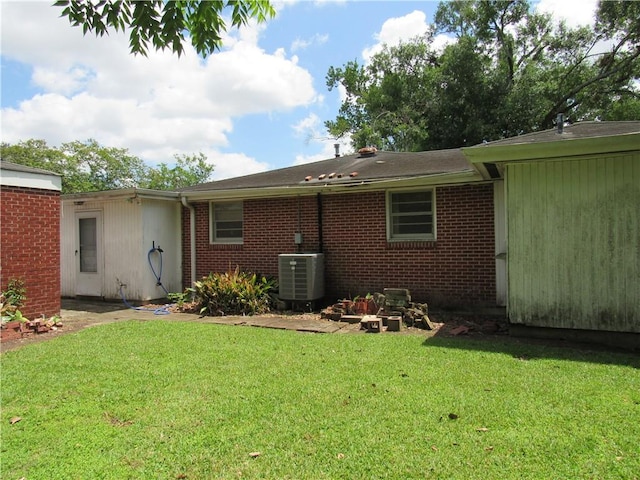 6735 W Magnolia Blvd, Harahan, LA 70123 - rear view of house featuring a lawn, central air condition unit, and brick siding