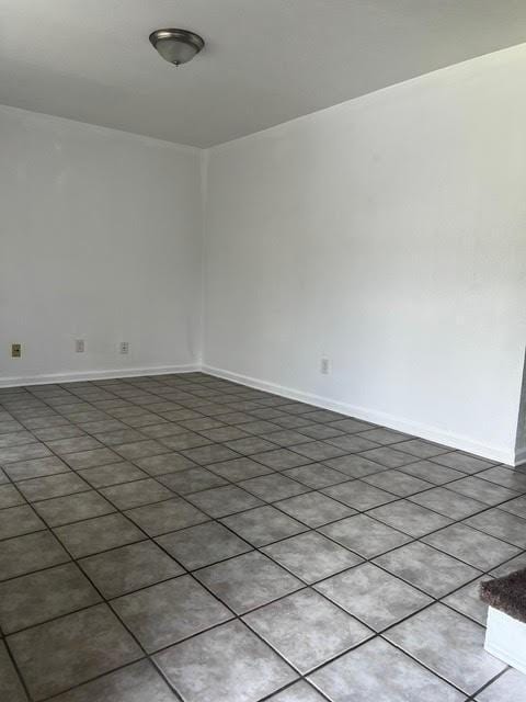 unfurnished room featuring baseboards
