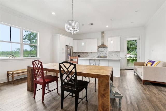 2321 Mehle St, Arabi, LA 70032 - dining space with crown molding, dark wood-style floors, a notable chandelier, and visible vents