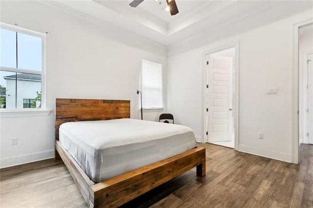 2321 Mehle St, Arabi, LA 70032 - bedroom featuring wood finished floors, a raised ceiling, crown molding, and baseboards