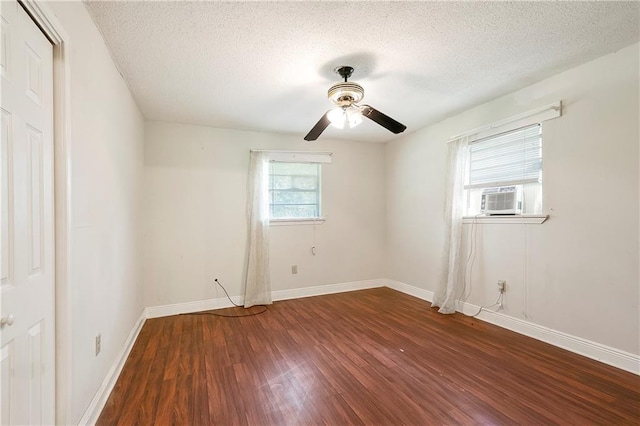 2751 Washington Ave, Slidell, LA 70458 - spare room featuring dark wood finished floors, a ceiling fan, a textured ceiling, baseboards, and cooling unit