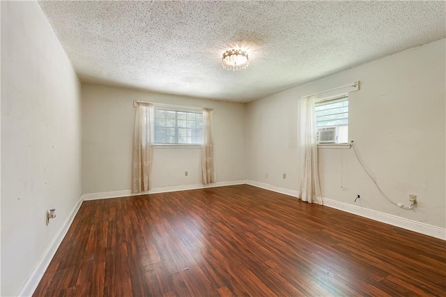 2751 Washington Ave, Slidell, LA 70458 - spare room featuring plenty of natural light, wood finished floors, a textured ceiling, and baseboards