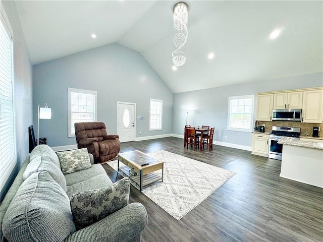 4132 Martin Luther King Jr Blvd, New Orleans, LA 70125 - living area featuring plenty of natural light, high vaulted ceiling, dark wood finished floors, and baseboards