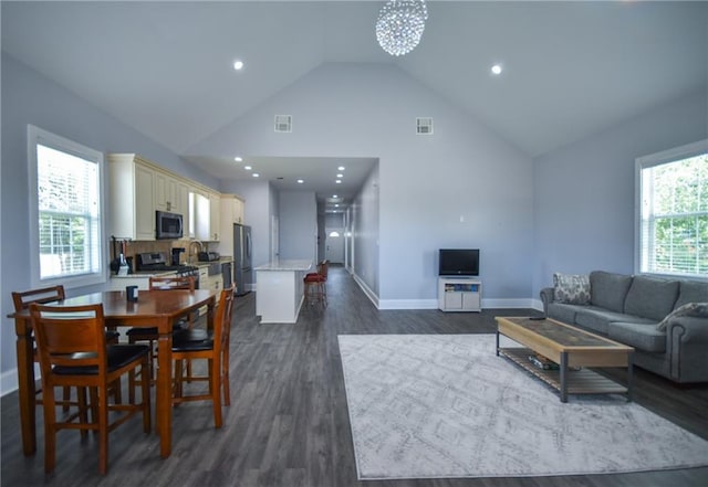 4132 Martin Luther King Jr Blvd, New Orleans, LA 70125 - living area featuring baseboards, visible vents, dark wood-type flooring, and high vaulted ceiling
