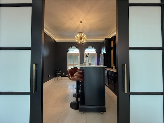 interior space featuring ornamental molding and a chandelier
