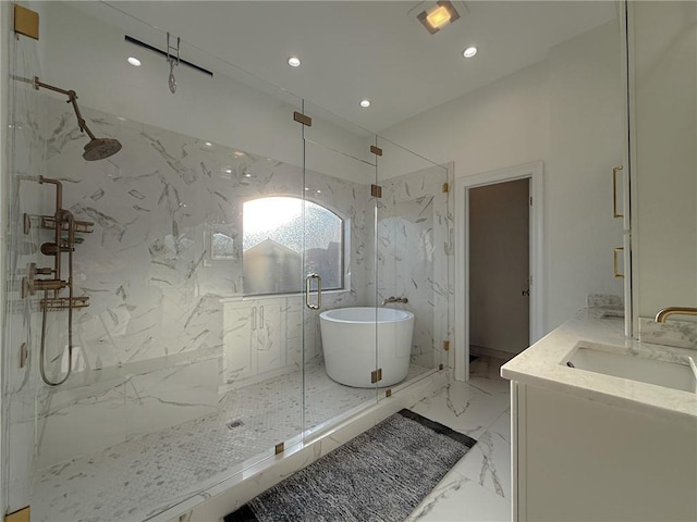 bathroom featuring recessed lighting, vanity, a marble finish shower, a freestanding bath, and marble finish floor