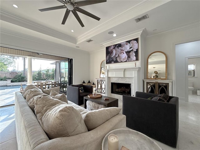 living room featuring recessed lighting, ceiling fan, a fireplace, visible vents, and crown molding