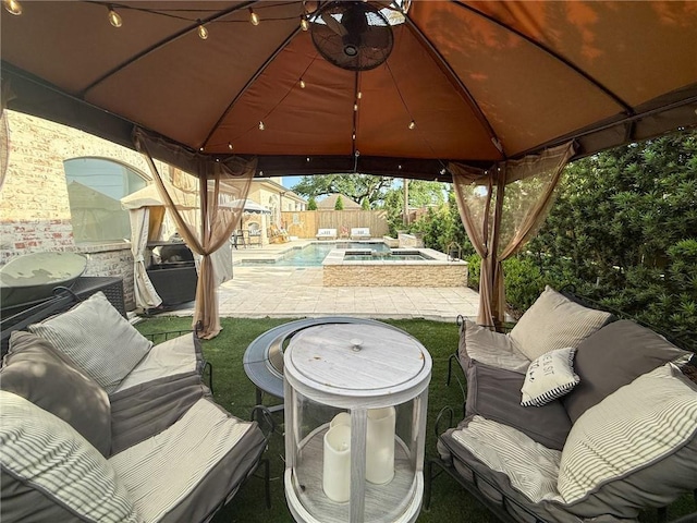 view of patio with a gazebo, a pool with connected hot tub, an outdoor living space, and a fenced backyard