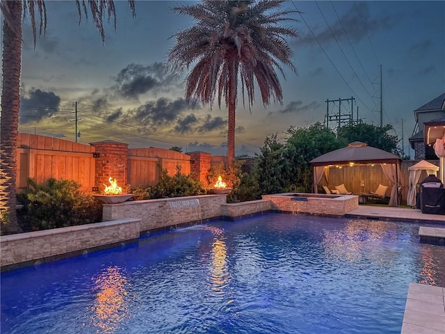 view of pool with a gazebo, a fenced backyard, and a pool with connected hot tub