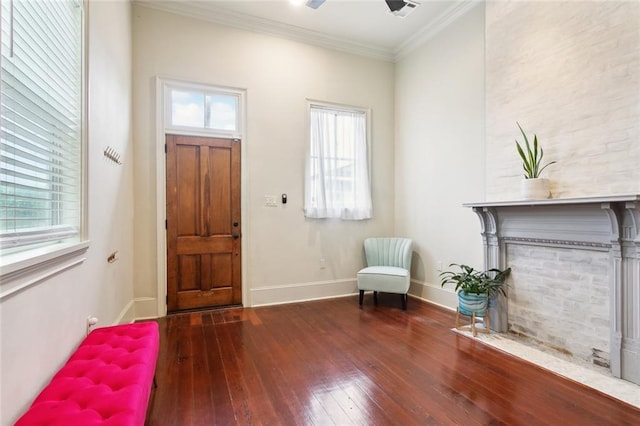 entryway with wood-type flooring, ornamental molding, a wealth of natural light, and baseboards