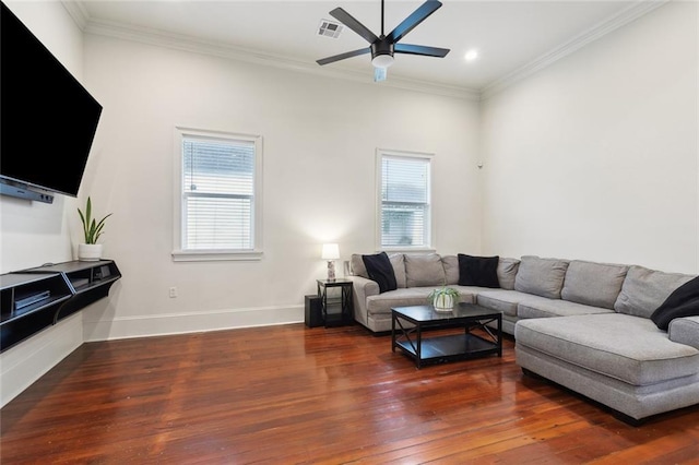 living room with crown molding, a ceiling fan, wood finished floors, and a healthy amount of sunlight