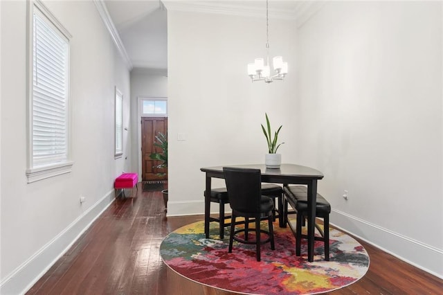 dining space featuring ornamental molding, an inviting chandelier, hardwood / wood-style flooring, and baseboards