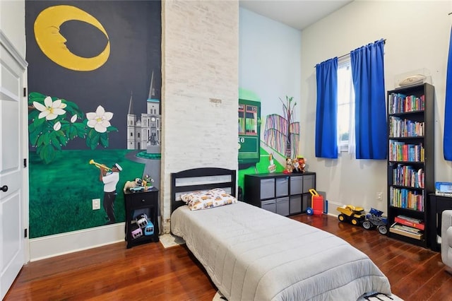 bedroom with hardwood / wood-style floors and baseboards