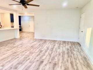 unfurnished living room featuring baseboards, ceiling fan, and wood finished floors