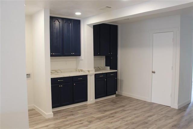 3024 Hero Dr, Gretna, LA 70053 - kitchen featuring light wood finished floors, baseboards, light stone counters, and recessed lighting