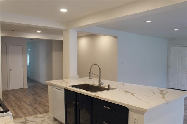 3024 Hero Dr, Gretna, LA 70053 - kitchen featuring a sink, wood finished floors, dishwasher, dark cabinetry, and light stone countertops
