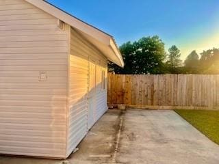 view of property exterior with a fenced backyard and a patio area