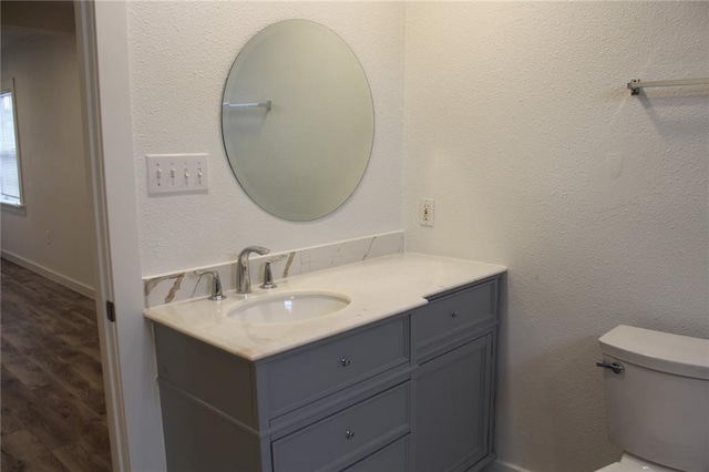 3024 Hero Dr, Gretna, LA 70053 - bathroom featuring vanity, toilet, and wood finished floors
