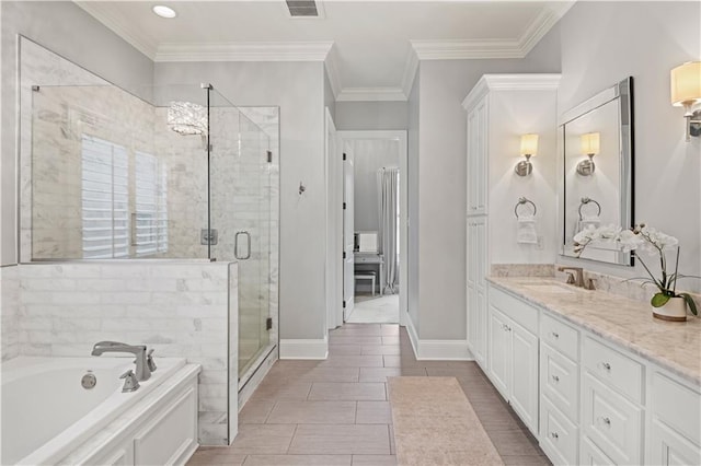 bathroom with vanity, ornamental molding, a stall shower, visible vents, and a garden tub